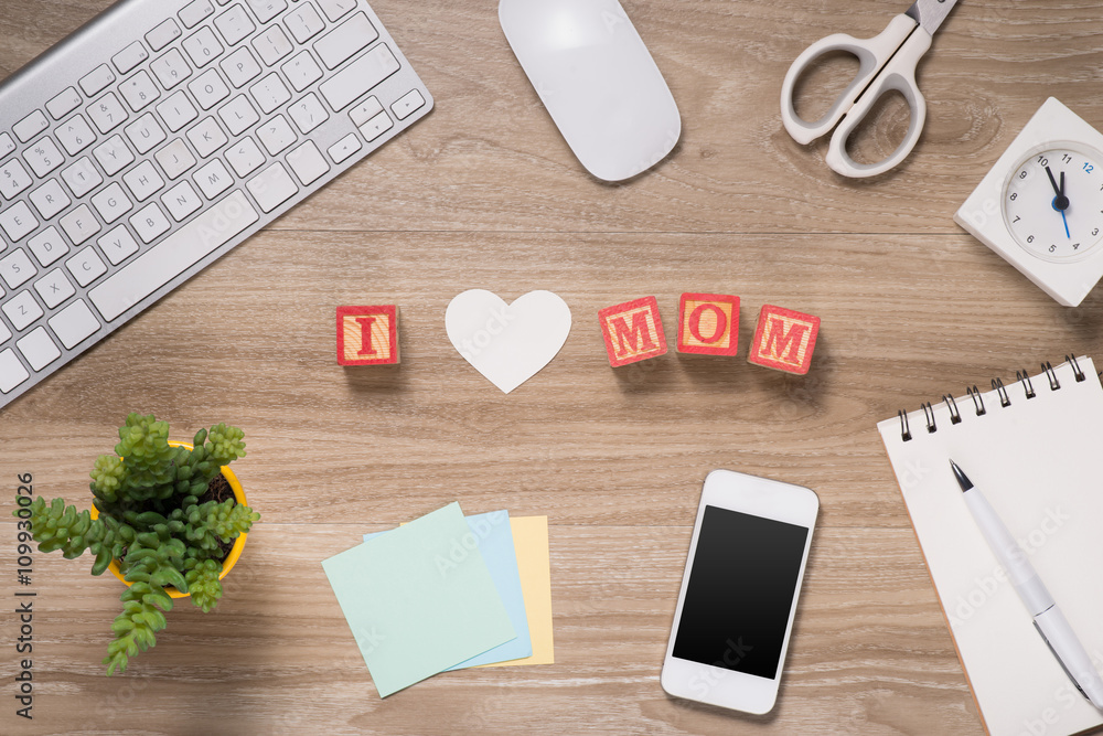 I love mom spelled with red alphabet blocks on office desk - Mothers Day