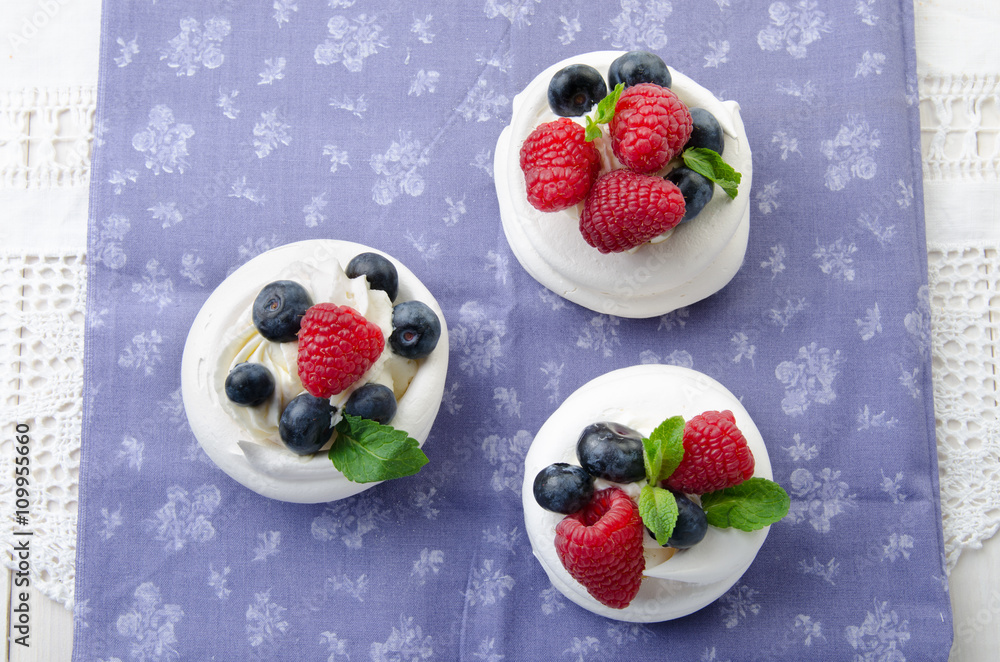 Homemade pavlova meringue cake with fresh berries and whipped cream. Morning. Dessert.