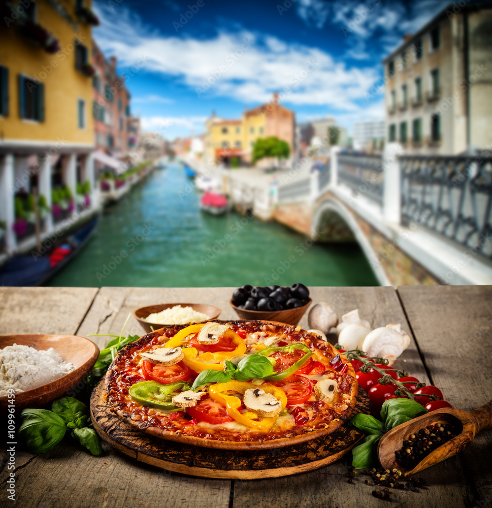 Rustic pizza with old city Italy background