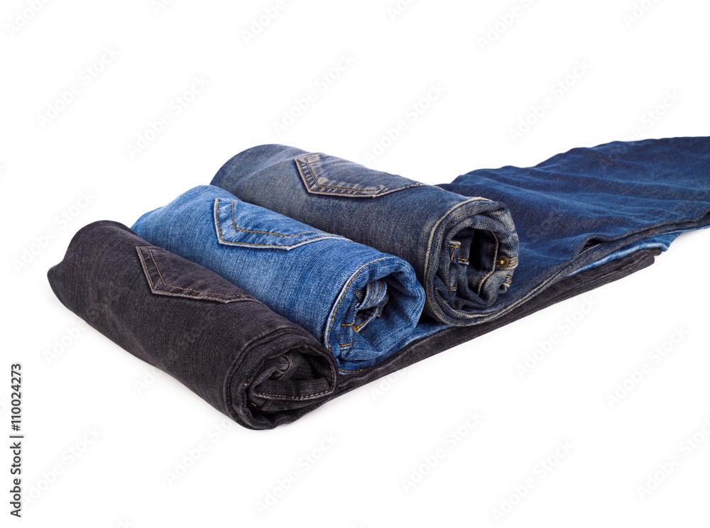 Three rolled denim jeans isolated on white