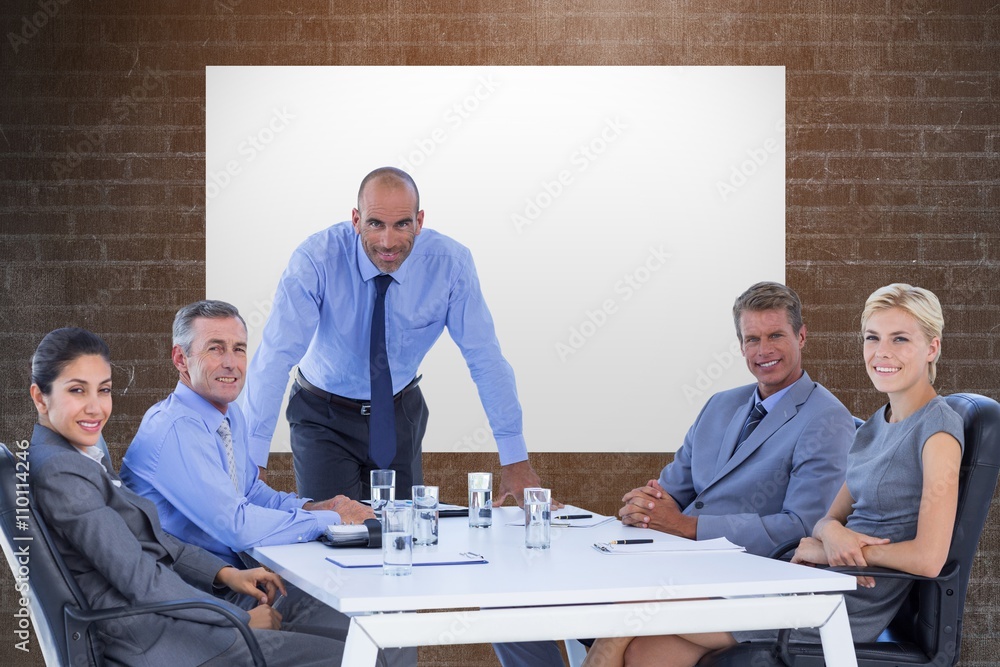 Composite image of happy business people looking at camera