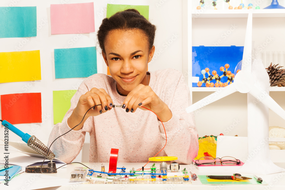 African student completing an electrical circuit