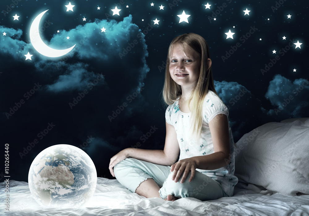 Girl in her bed and glowing globe