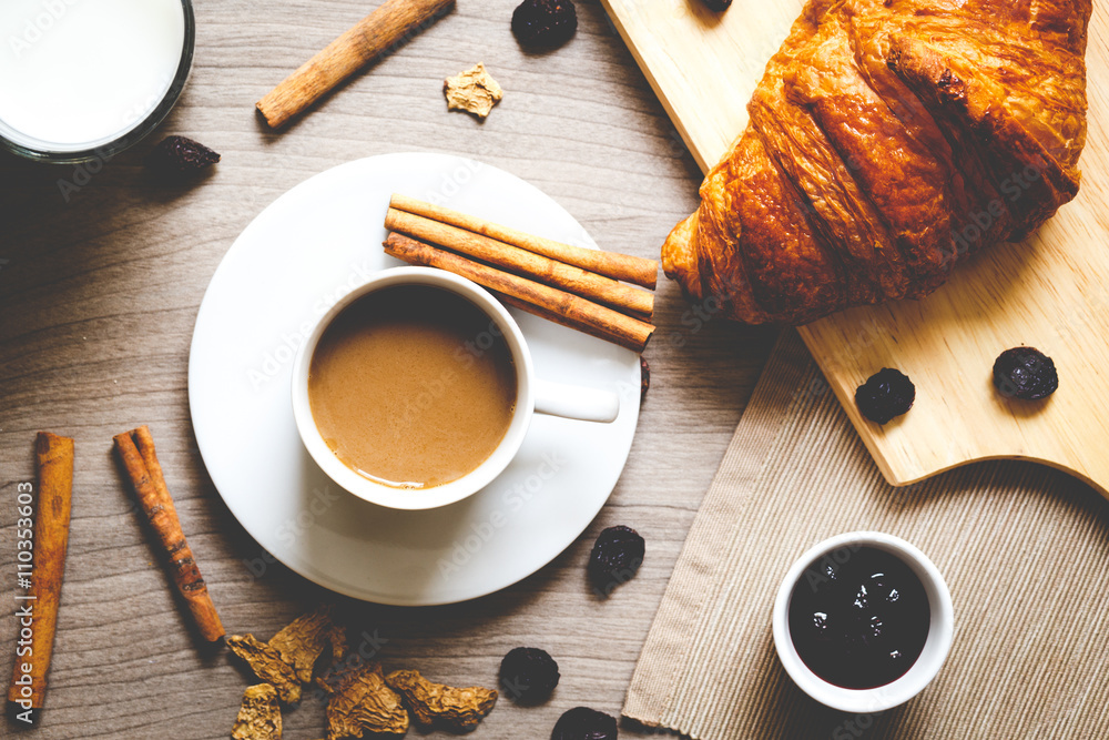 Breakfast with coffee and croissants on wooden table