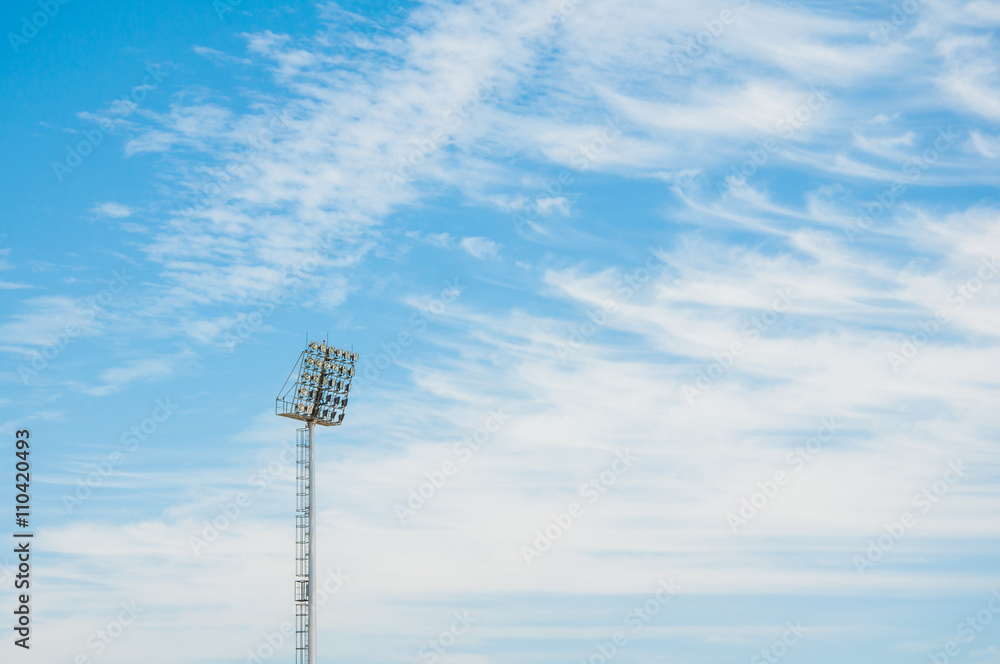 Stadium floodlight tower with blue sky background