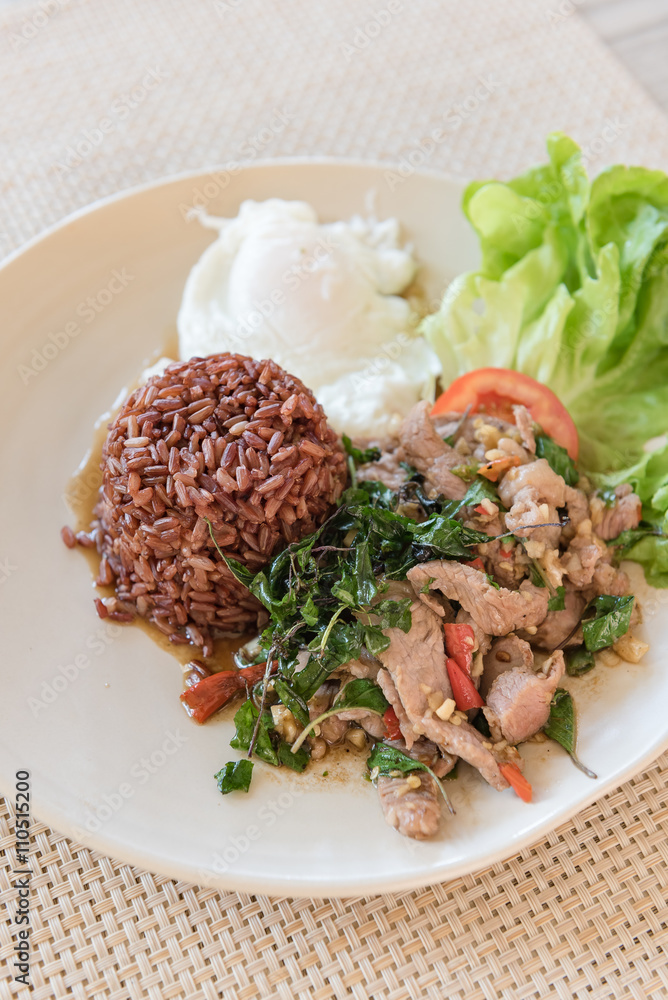 Rice topped with stir-fried beef and basil with  fried egg