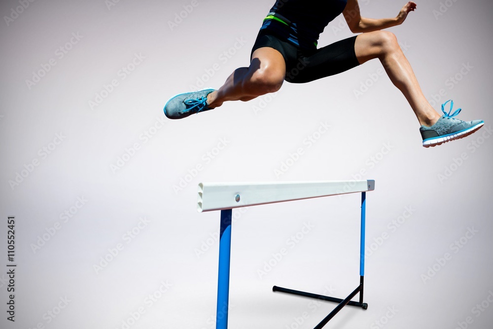 Composite image of athletic woman doing show jumping