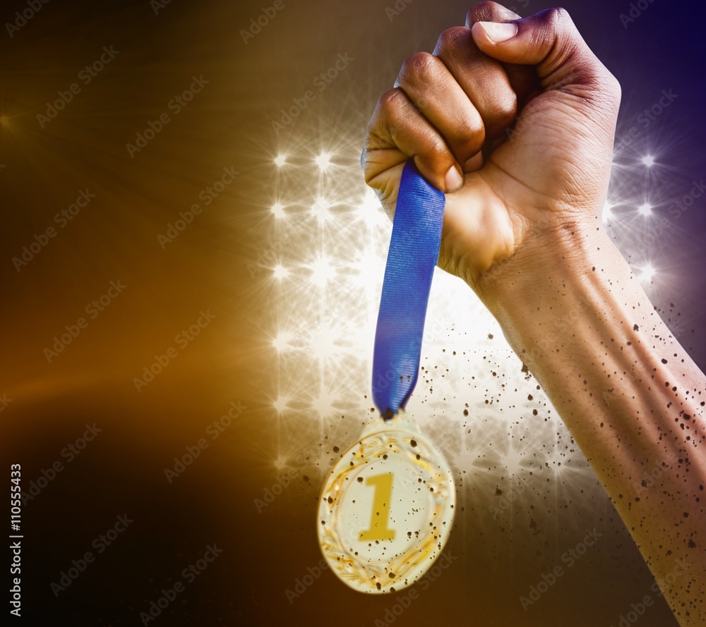 Composite image of hand holding a silver medal on white backgrou