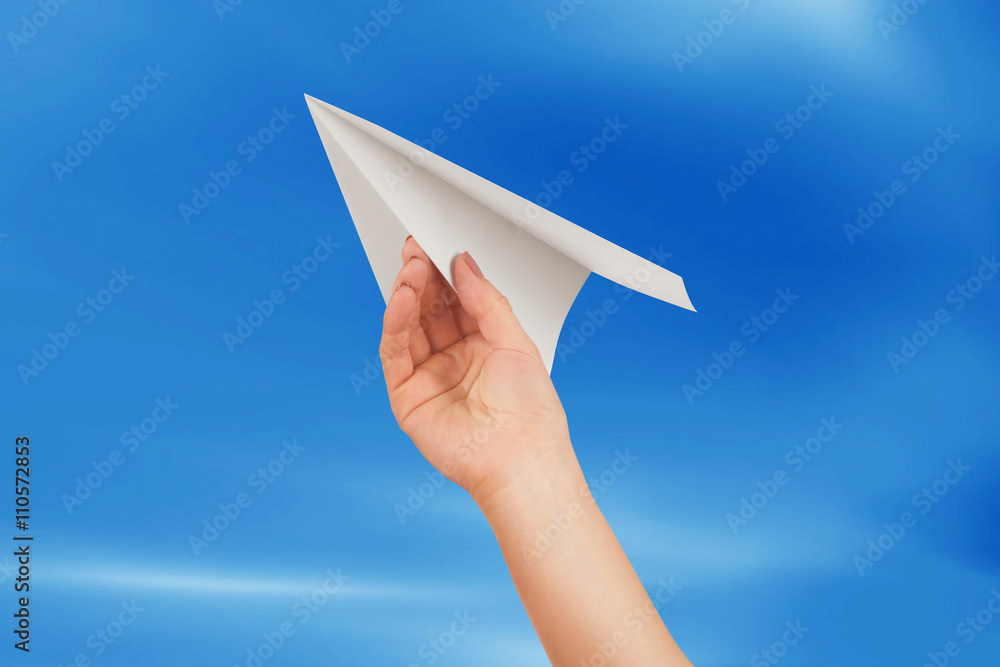 Businesswoman throwing white paper plane