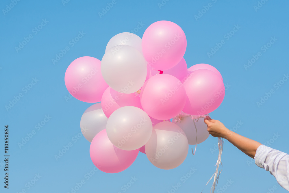 woman hands holding many balloons