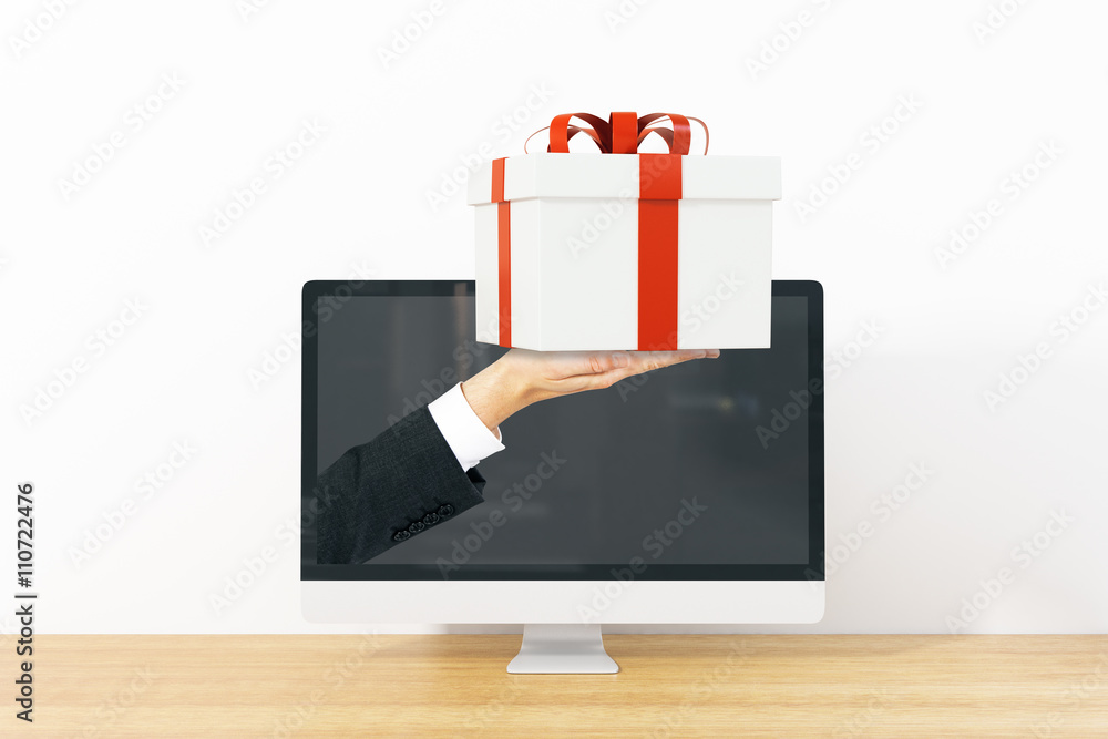 Businessman handing present from screen