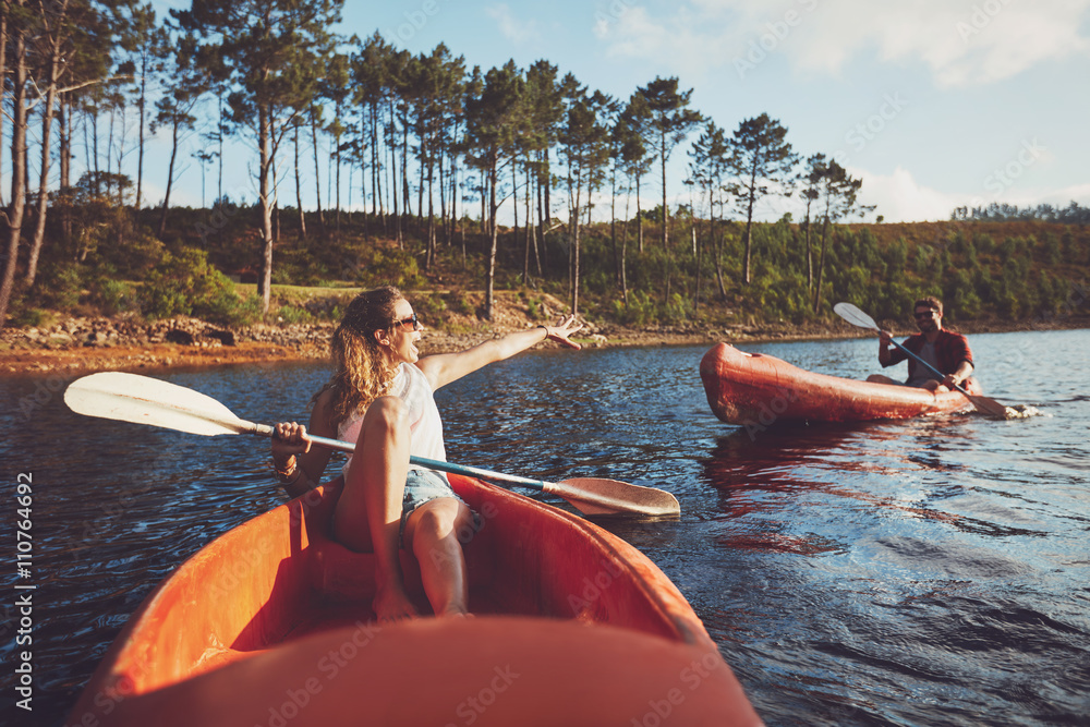 Young couple kayaking on the lake