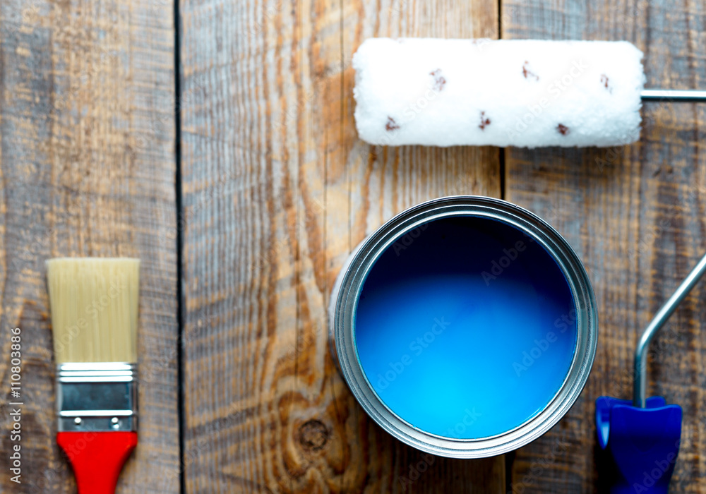 concept preparation for painting with  can of blue paint