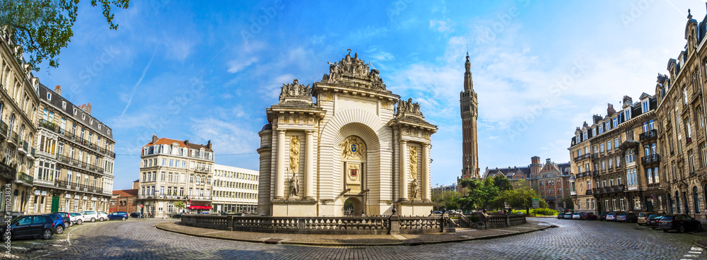 View of french city Lille with belfry, council hall and Paris’ gate