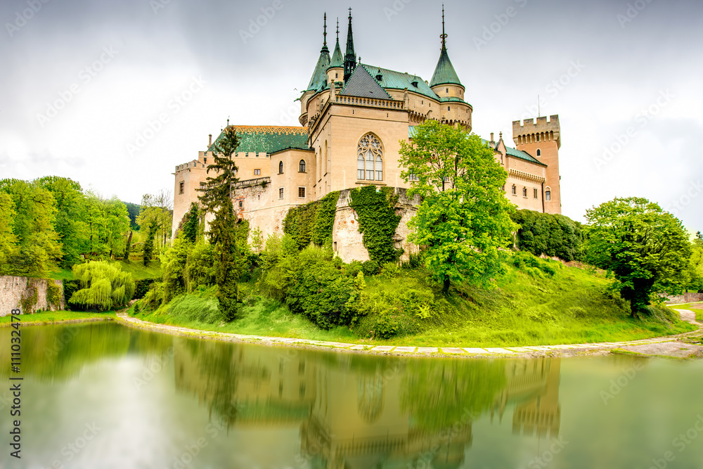 View on Bojnice castle from the lake with reflection in Slovakia. 