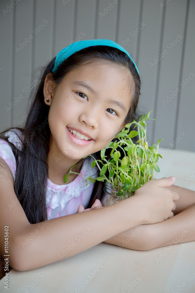 Happy Asian girl hugging tree pot, Environment concept.