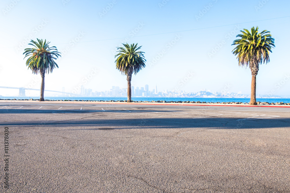 asphalt road near sea with cityscape and skyline of san francisc