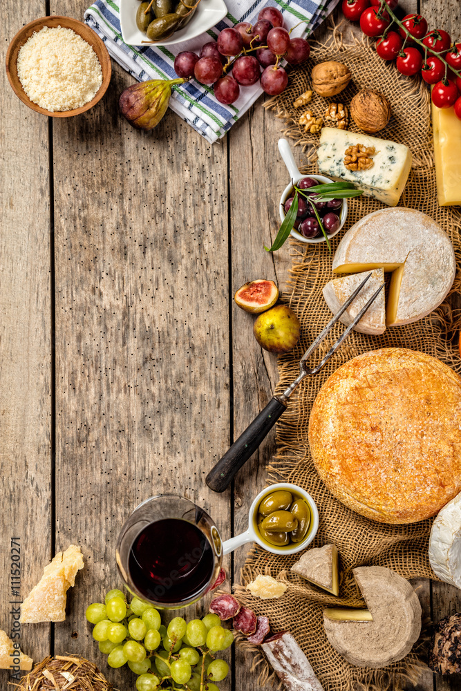 Various kind of cheese and delicacy on wood