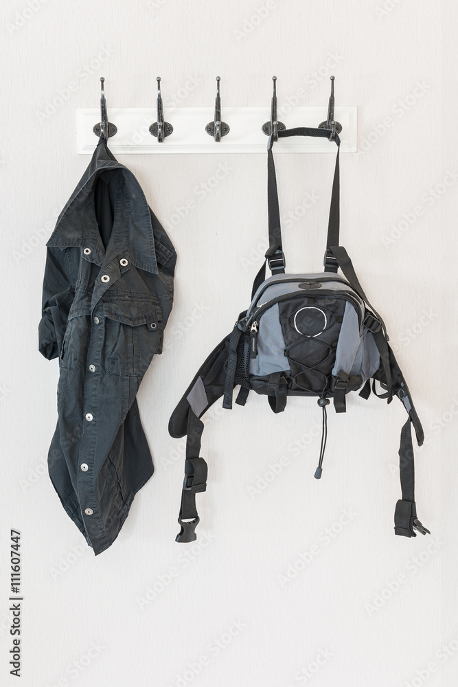 black shirt and bag hanging on hook