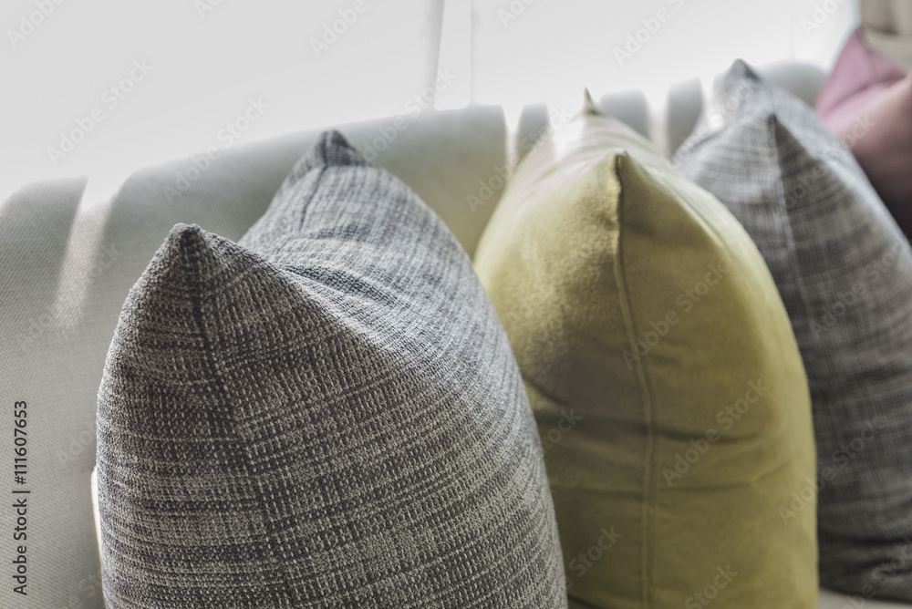 row of pillows on white sofa in living room