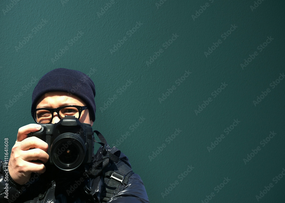 Portrait of young man photographer with camera. paparazzi