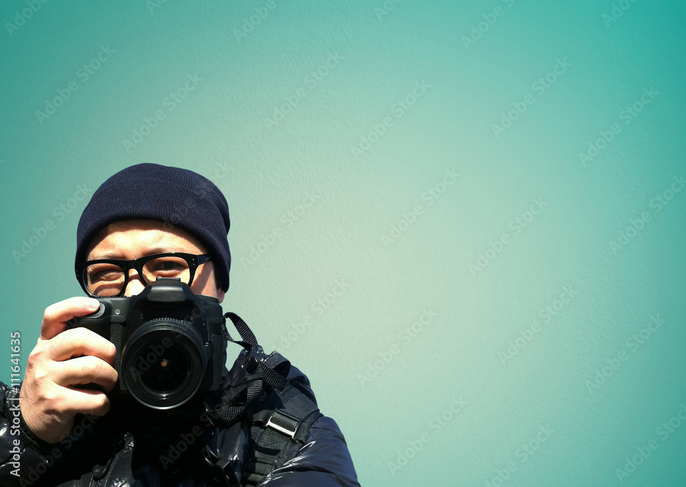 Portrait of young man photographer with camera. paparazzi