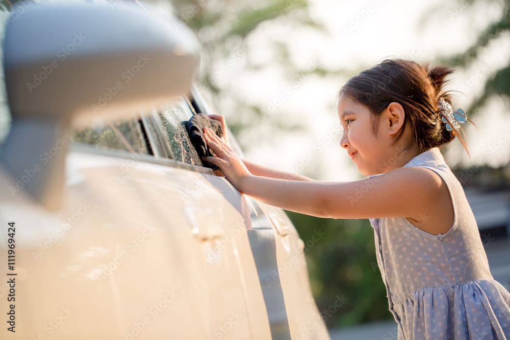 快乐的亚洲女孩在家泼水和阳光下洗车