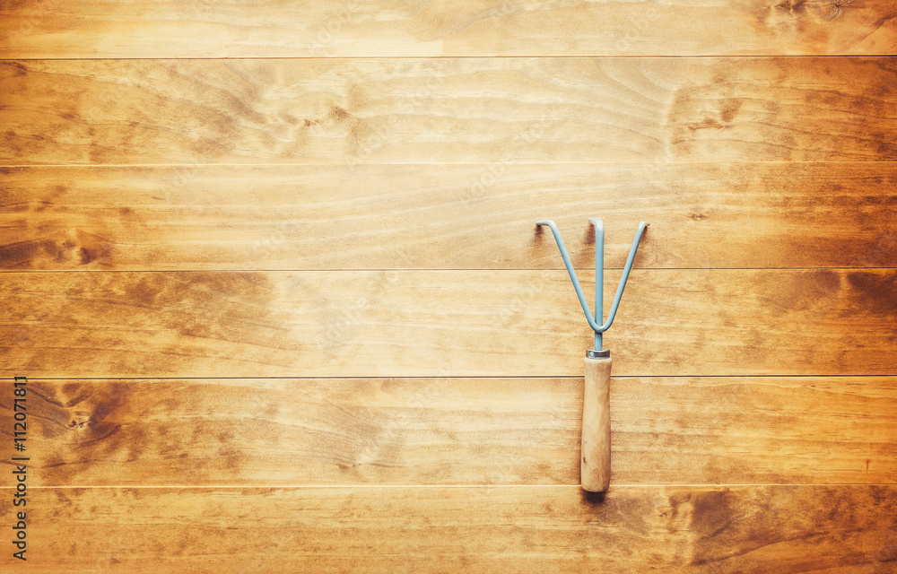 Cultivator garden tool on a rustic table