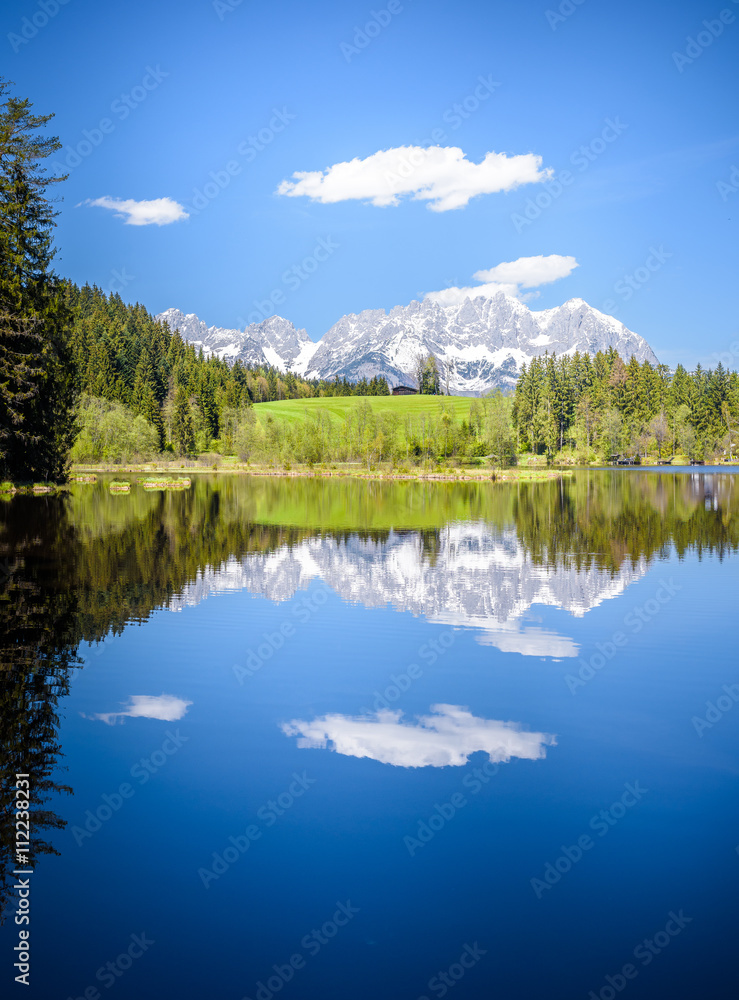 Wilder Kaiser reflecting in mountain lake, Kitzbühel, Tyrol, Austria