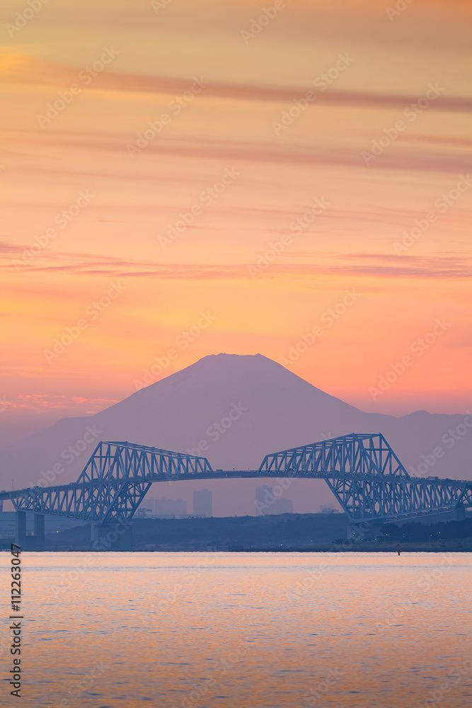 Tokyo bay at sunset with Tokyo gate bridge and Mountain Fuji .