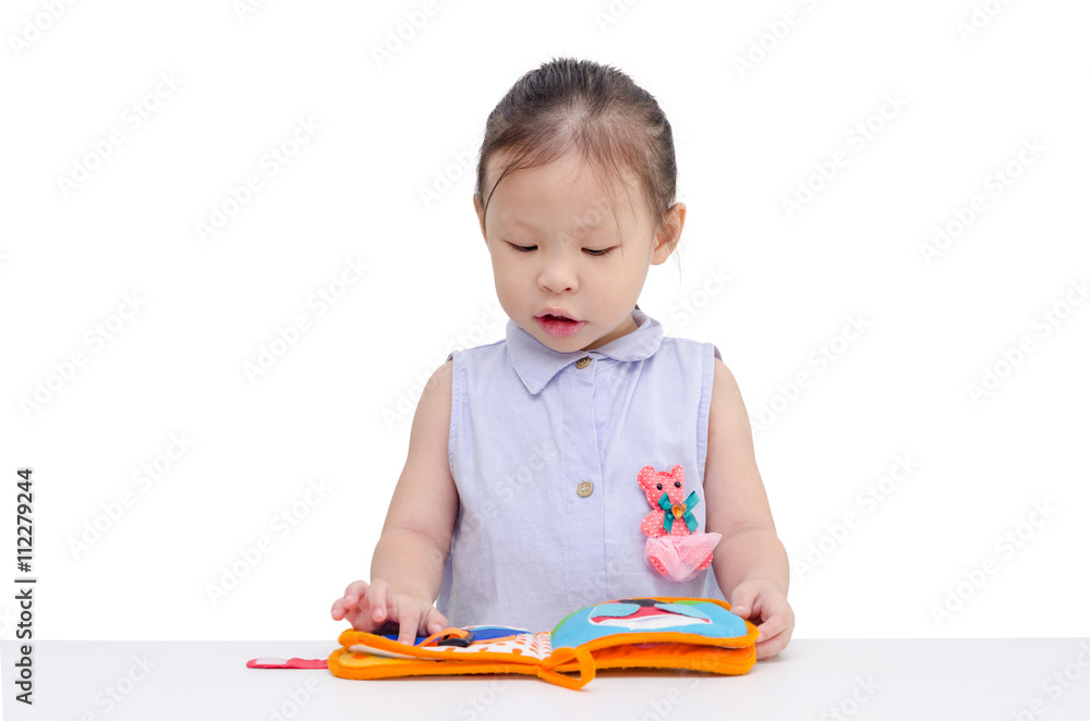 Little asian girl reading book over white background