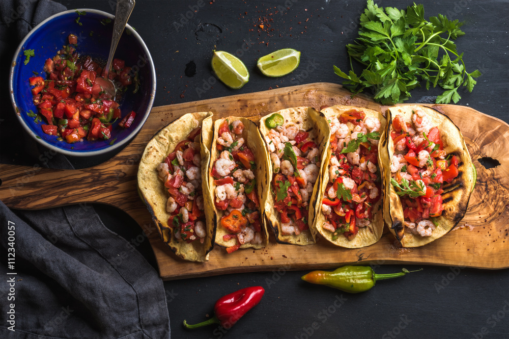 Shrimp tacos with homemade salsa, limes and parsley