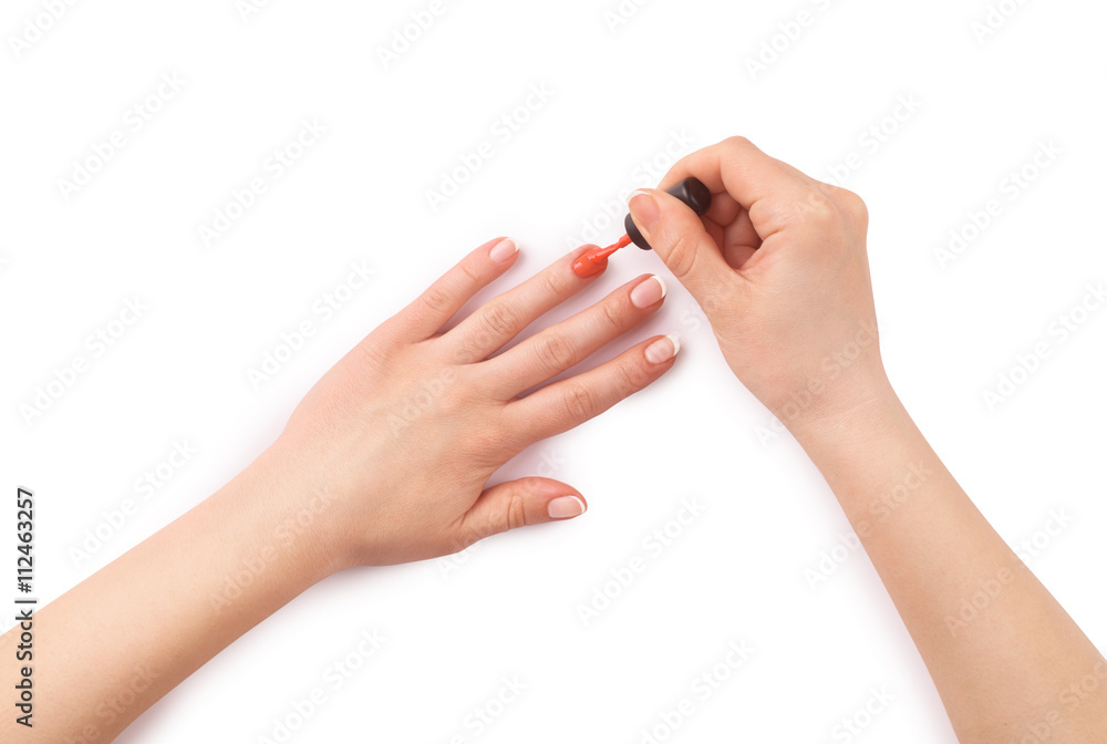 woman paints her nails on white