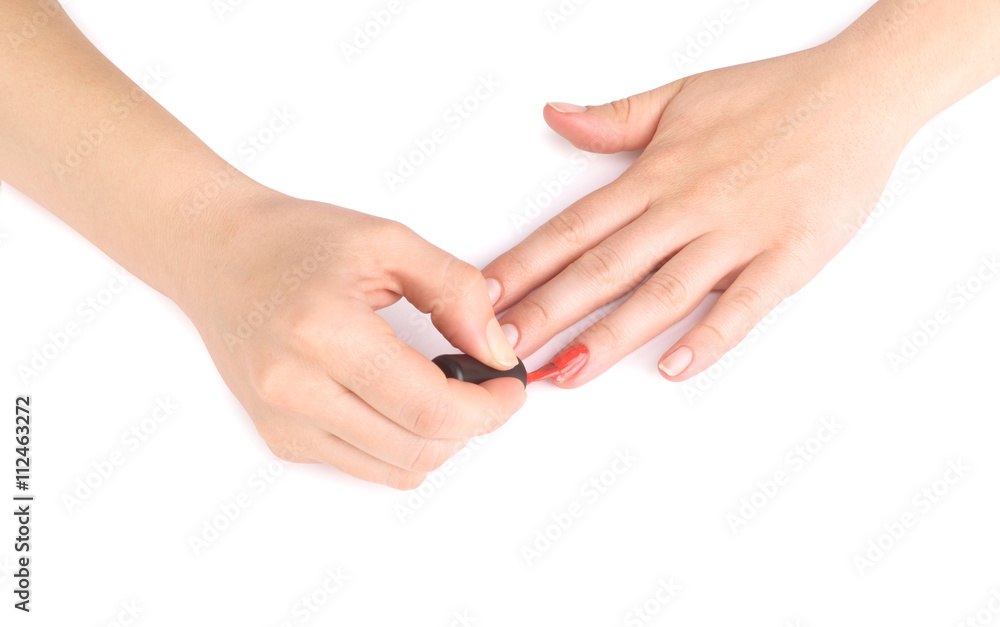 woman paints her nails on white