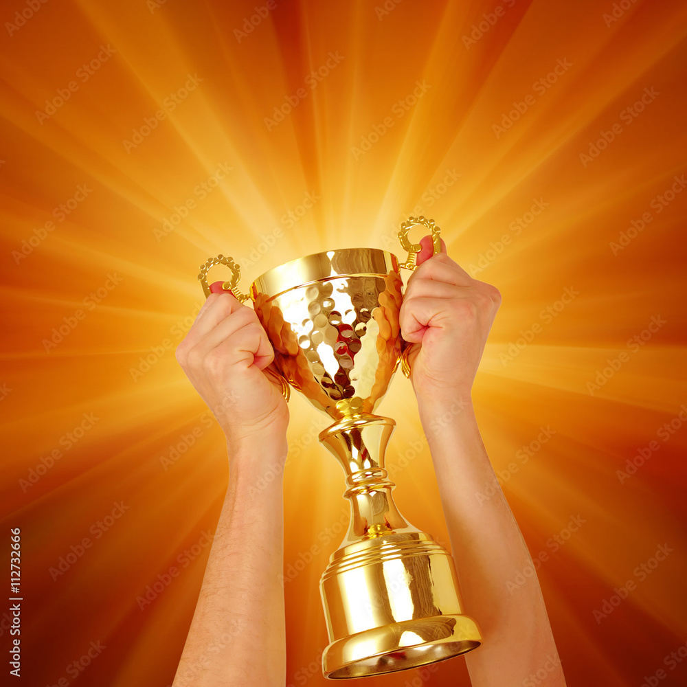 Man holding a champion golden trophy