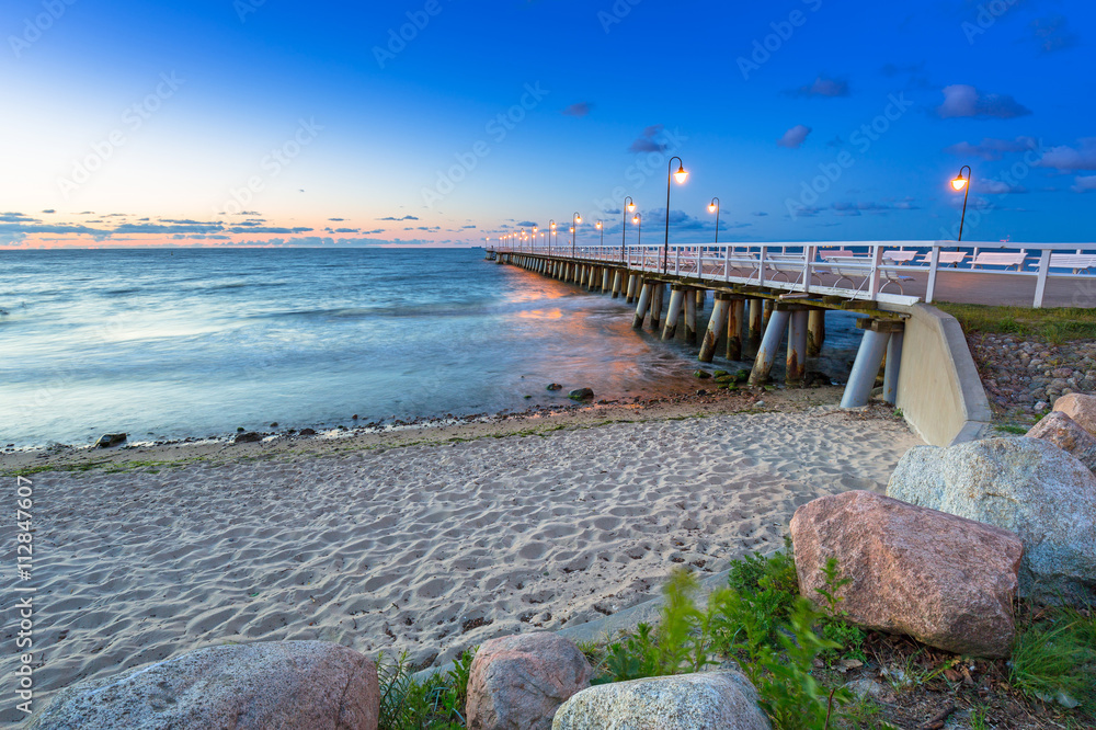 Baltic sea with pier in Gdynia Orlowo at sunrise, Poland