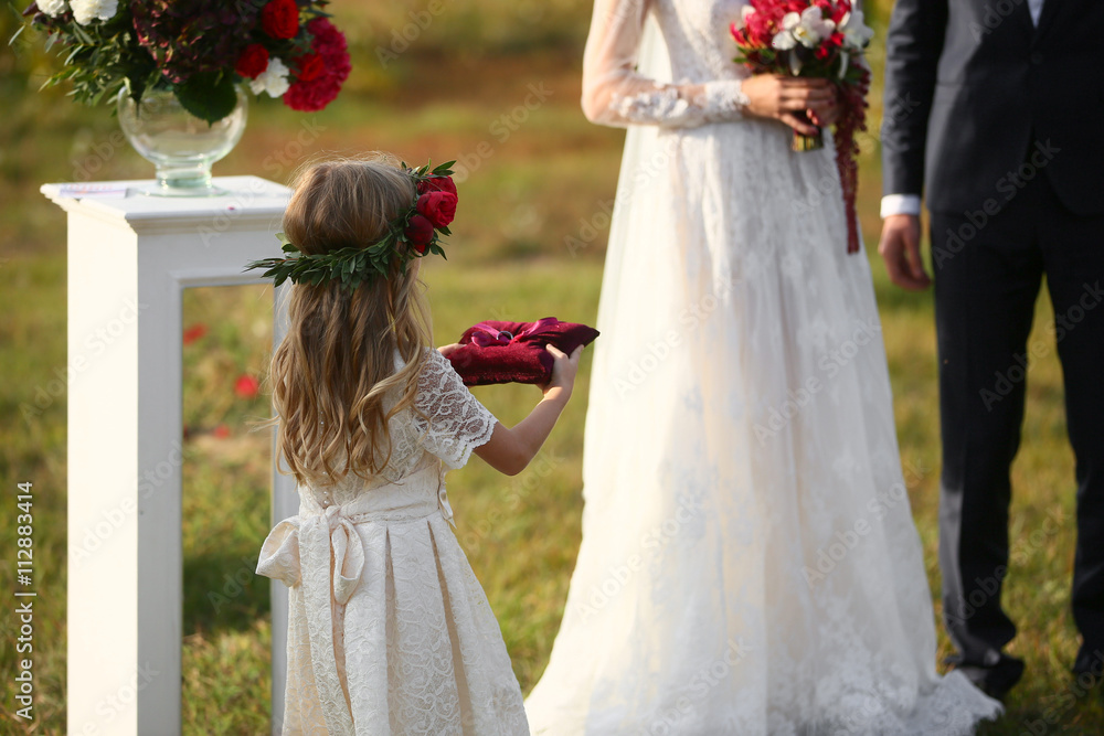 little girl Carrying Wedding Ring On Cushion