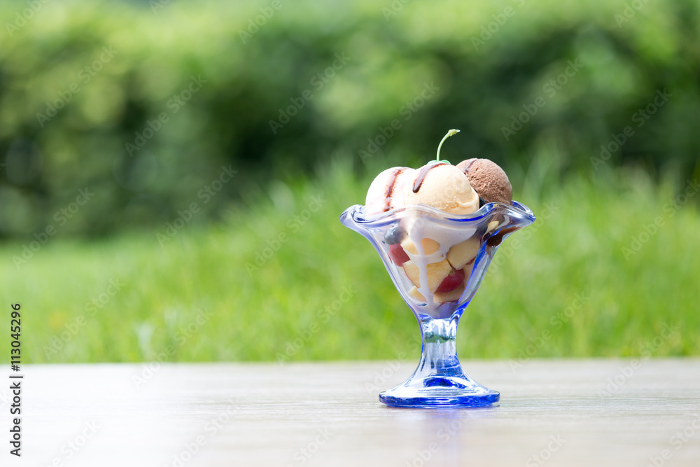 tasty icecream ball in glass with green grass