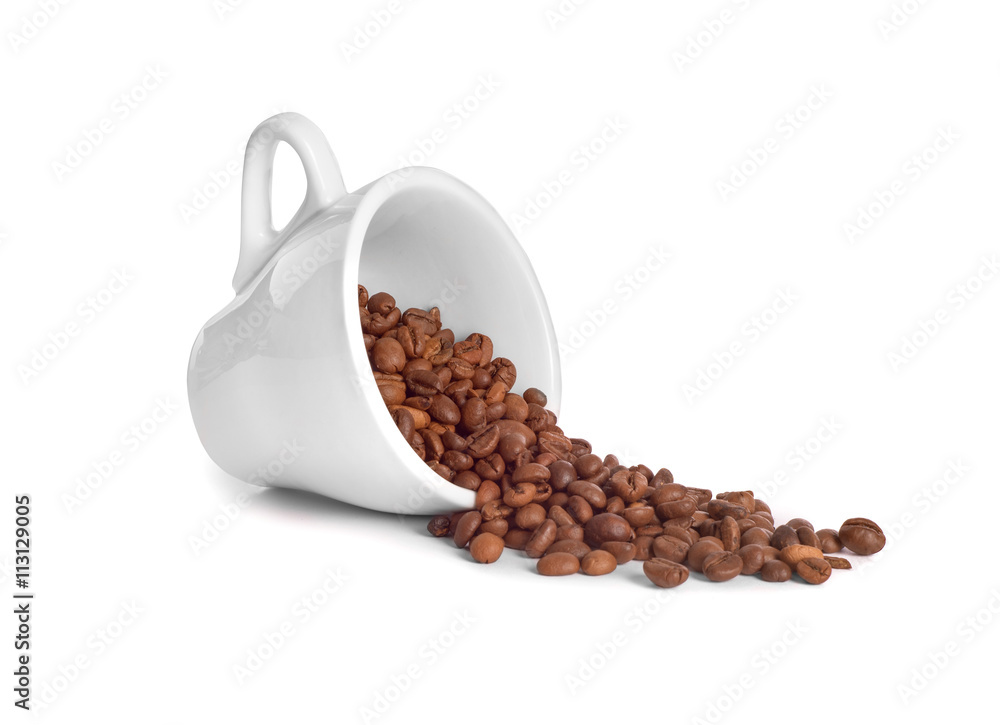 coffee beans poured from a cup on white