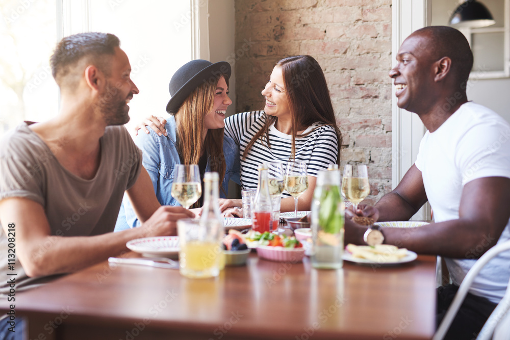 Woman hugging friend at dinner table