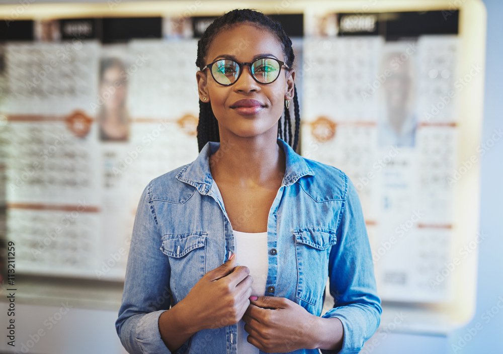 Happy woman with new glasses in vision care store