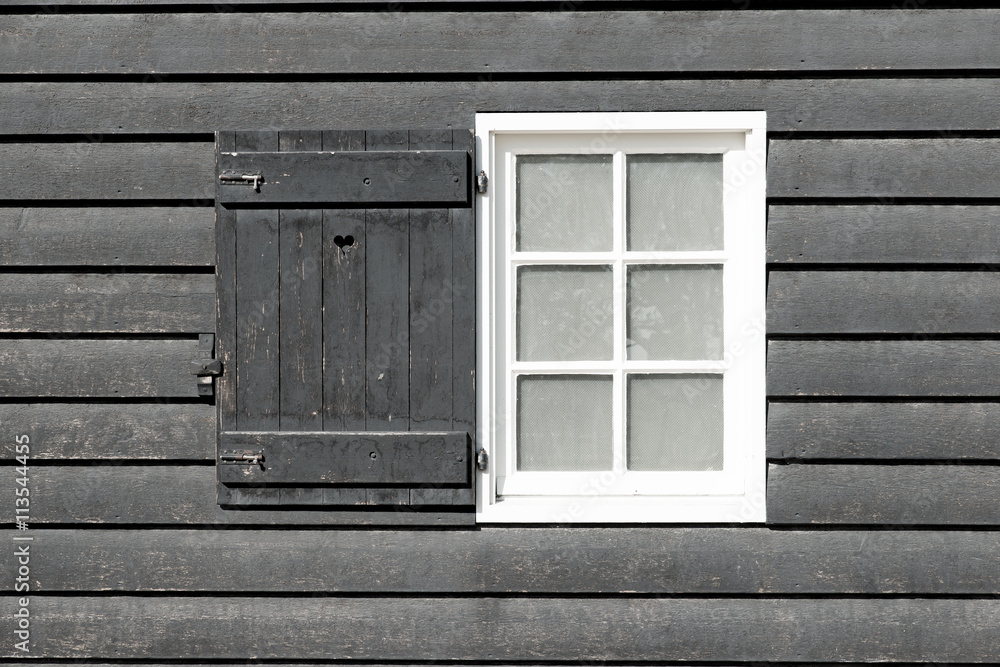 Black old wood window in country house. White window on black wo