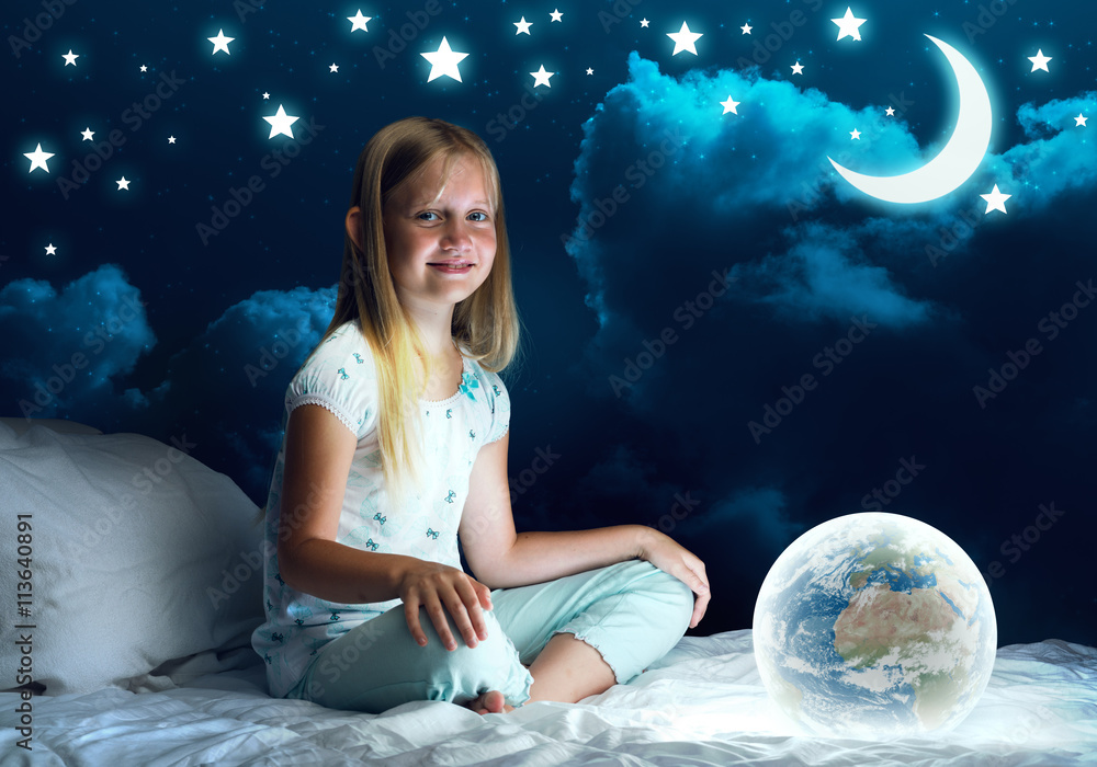 Girl in her bed and glowing globe