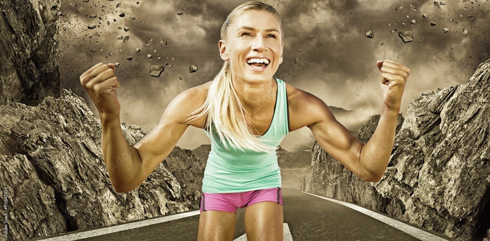 Composite image of portrait of sportswoman smiling and raising arms