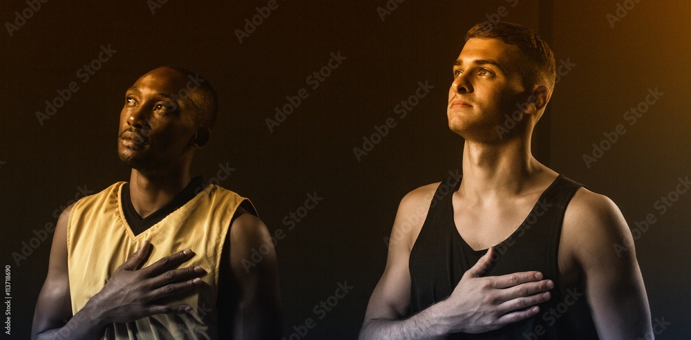 Portrait of basketball players putting hand on heart