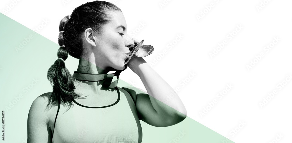 Sportswoman kissing her medals 