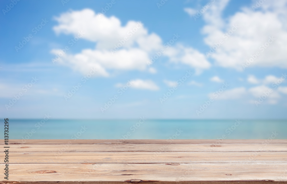 Wood floor on blur clear sky and island beach Summer background.