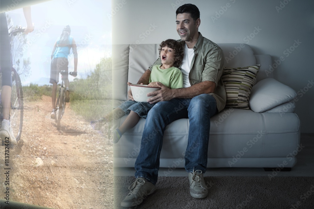 Father and son are watching biking on television