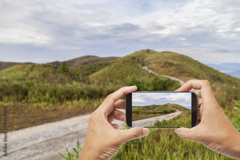 Hand male asian holding Smartphone taking picture of Mountain hi