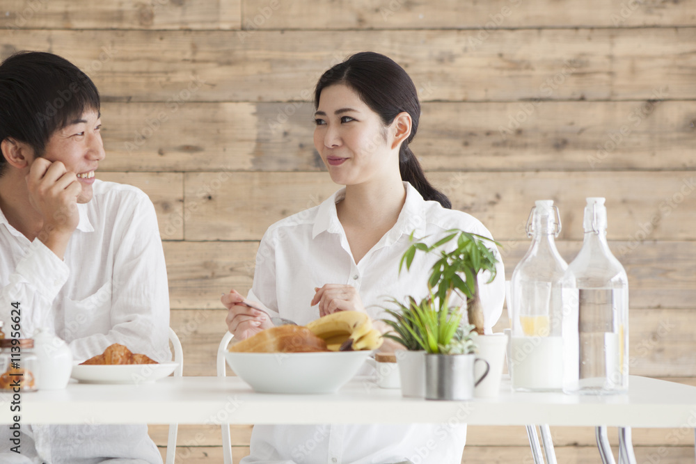 Newlywed couple is eating breakfast together